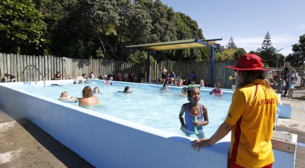 Fitzroy swimming pool. Lifeguard looking on as young children play. 